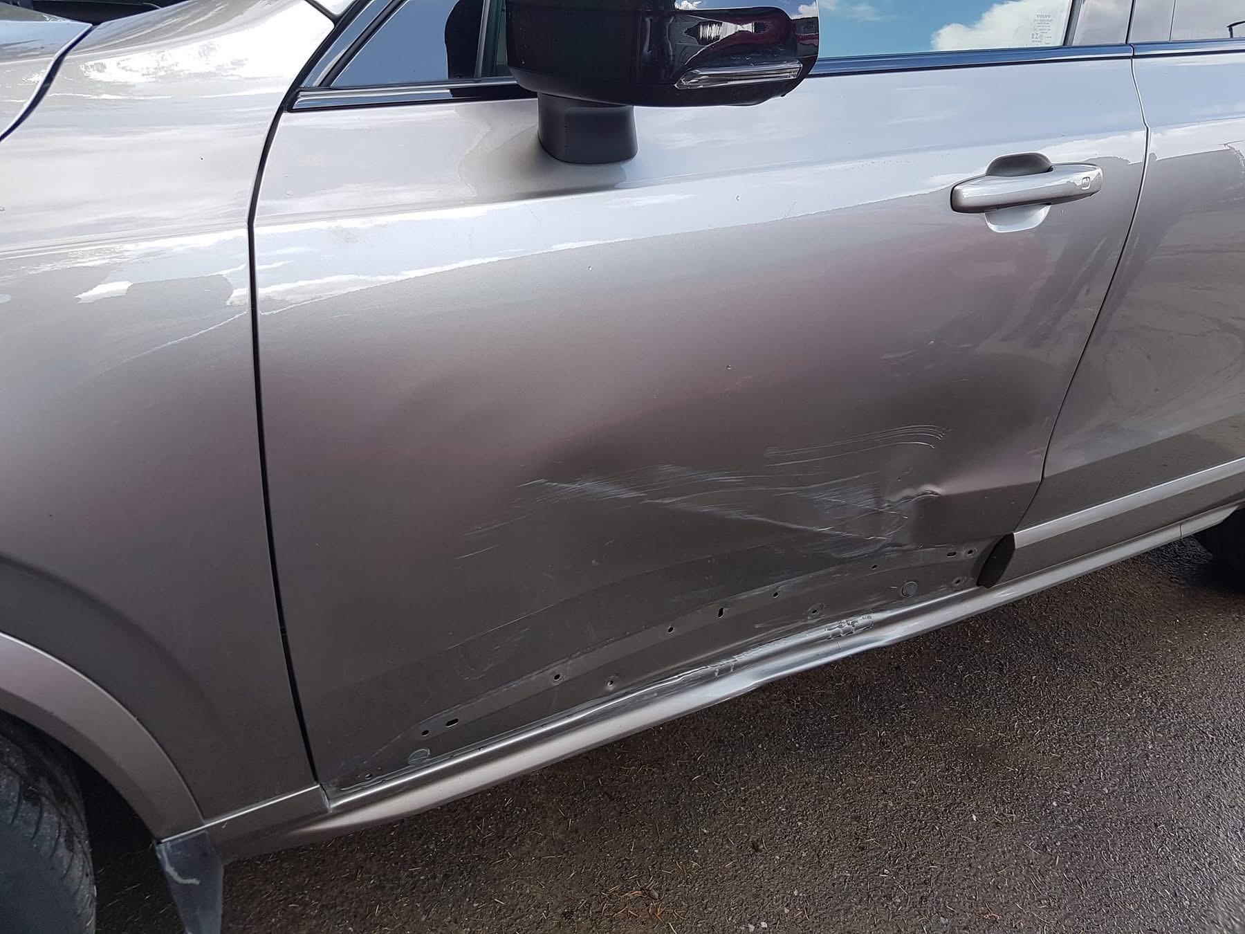 Before repair: dents and scratches along the nearside doors and sill of a Volvo XC90